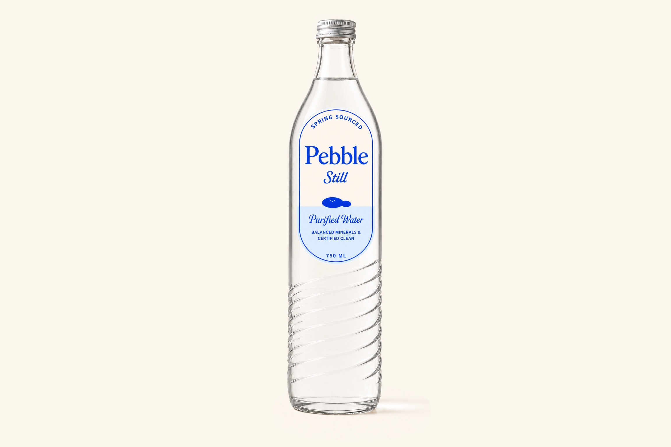 The Pebble glass bottle resting on grass
